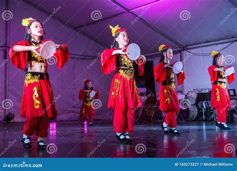 Young Asian Girls in Chinese Folk Dance Costumes Performing on Stage ...