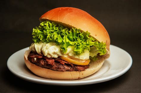 Burger With Lettuce and Cheese on a White Plate · Free Stock Photo