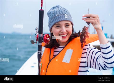 Young asian woman holding fishing hi-res stock photography and images ...