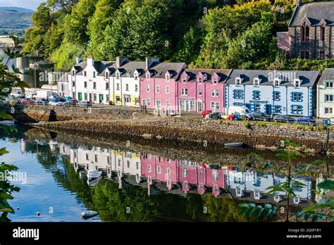 PORTREE, ISLE OF SKYE, SCOTLAND - SEPTEMBER 16, 2021: Colorful buildings line Portree harbour ...