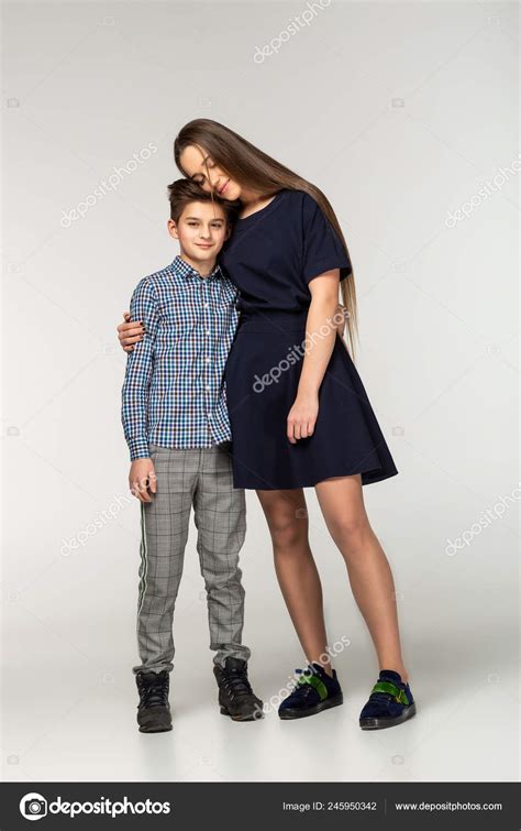 Beautiful sister and brother hugging tenderly indoors Stock Photo by ©ngvprod 245950342