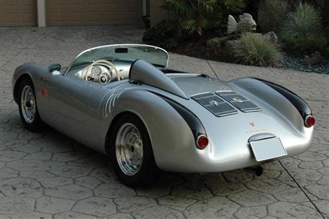 a silver sports car parked in front of a garage