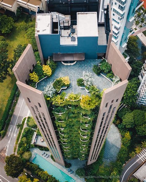 an aerial view of a building with trees and plants growing on the roof ...