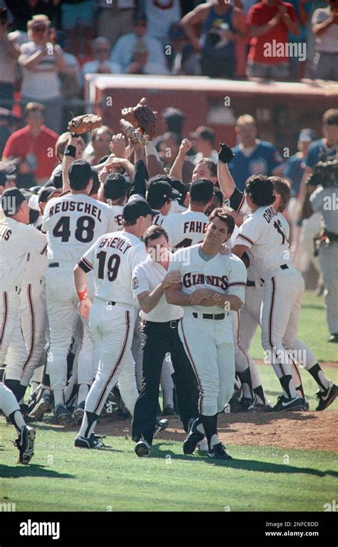 San Francisco Giants pitcher Dave Dravecky, front right, holds his arm as he is helped form the ...