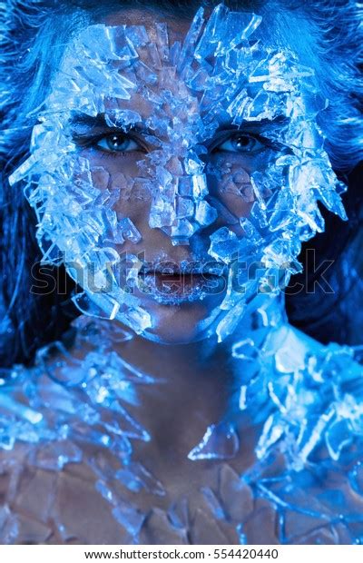 Female face covered with a lot small pieces of glass. Realistic visual effects made of silicone gel.