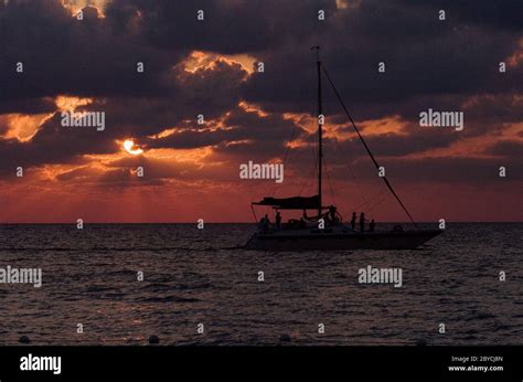 sailing boat sunset red and relax Stock Photo - Alamy