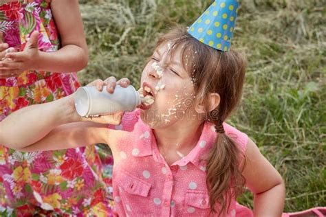 A Girl with a Dirty Face in Eating Whipped Cream. Stock Photo - Image of caucasian, dirty: 202950536