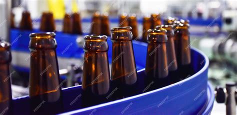 Premium Photo | Beer bottle in conveyor belt