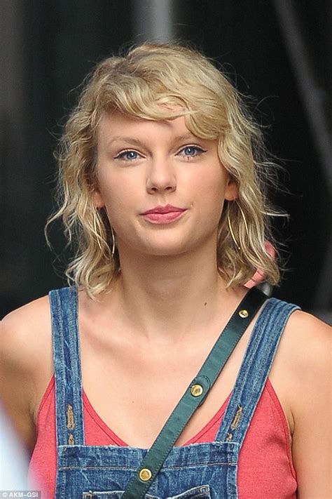 Taylor Swift sports kooky bedhead curls as she steps out in leggy denim overalls in NYC | Daily ...