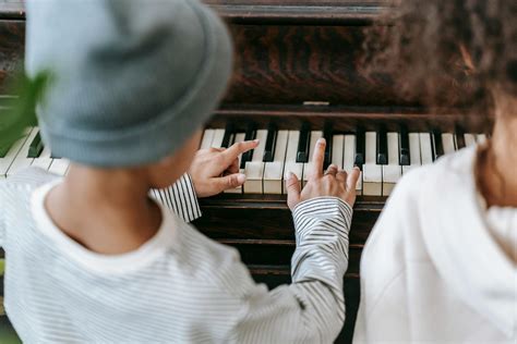 Unrecognizable ethnic children playing piano at home · Free Stock Photo