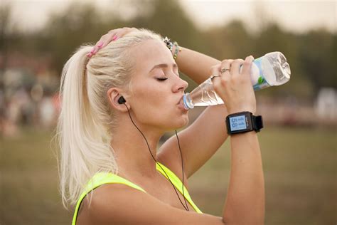 Download Blonde Woman Drinking Water From Bottle Wallpaper | Wallpapers.com