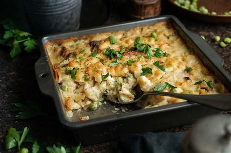 a casserole dish with broccoli, cheese and herbs in it on a table