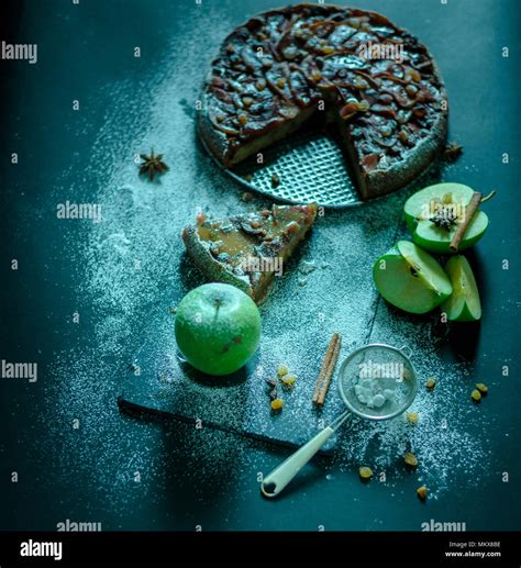 Apple pie with caramel cream on black table with sugar in background and apple Stock Photo - Alamy