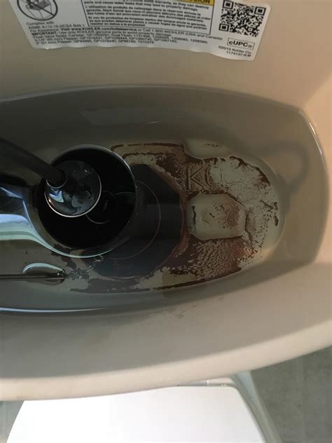 Toilet is flushing really slowly, and it has this brown/red sediment in the bottom of the tank ...