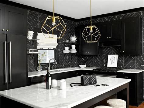 Black and white kitchen features black shaker cabinets paired with white marble countertops and ...