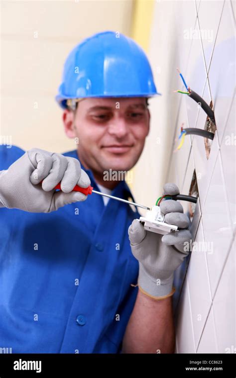 Electrician wiring a wall socket Stock Photo - Alamy