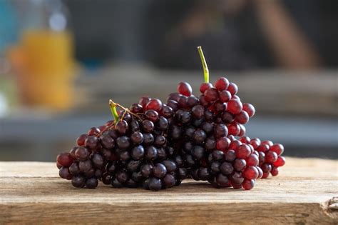 Premium Photo | Red grapes on a wooden table