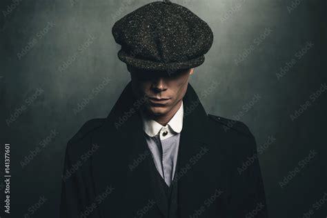 Mysterious portrait of retro 1920s english gangster with flat cap ...