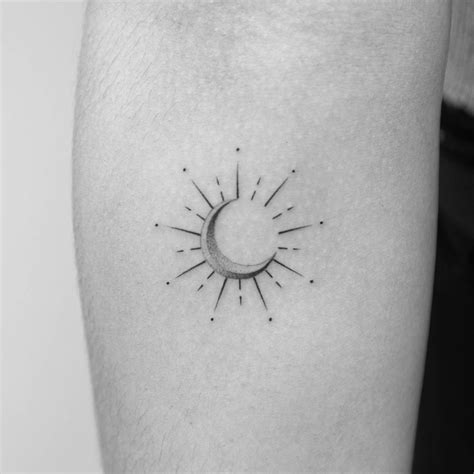 Minimalistic style eclipse tattoo located on the inner