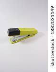 Free Image of Black Office Stapler Isolated on Blue Green | Freebie.Photography