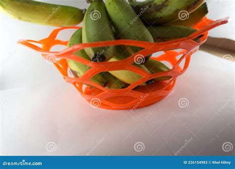 Bunch of Fresh Green Ambon Bananas in a Fruit Basket Isolated on a Blue ...