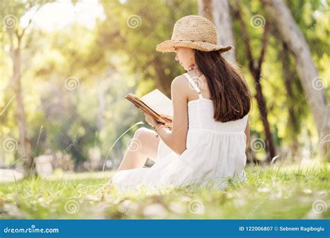 Reading a book at park stock image. Image of teenage - 122006807