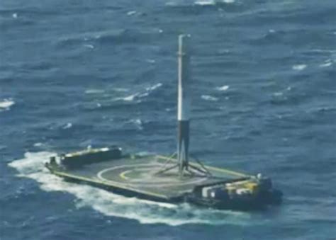 SpaceX successfully lands its Falcon 9 booster on a barge at sea.