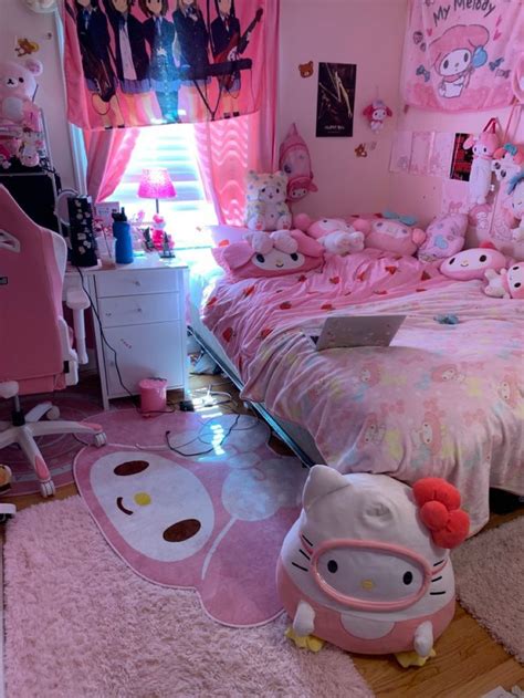 a bedroom with hello kitty decorations and pink walls