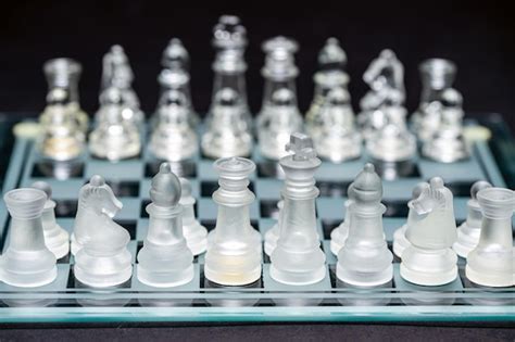 Premium Photo | Glass transparent chess pieces on a checkerboard selective focus closeup ...