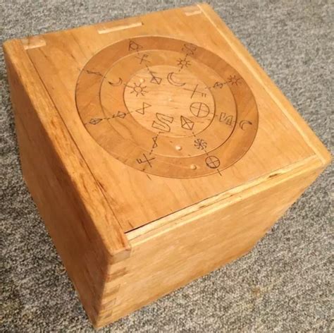 a wooden box with writing on it sitting on the floor next to a carpeted ...