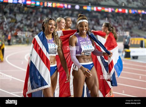 Amber Anning and Nicole Yeargin with her country's flag in the 4x400 ...