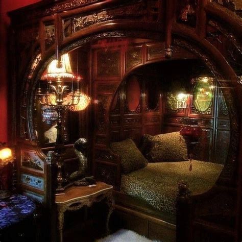 a bedroom with an ornate bed and mirror