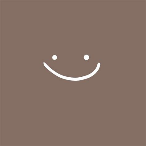 a smiling face on a brown background