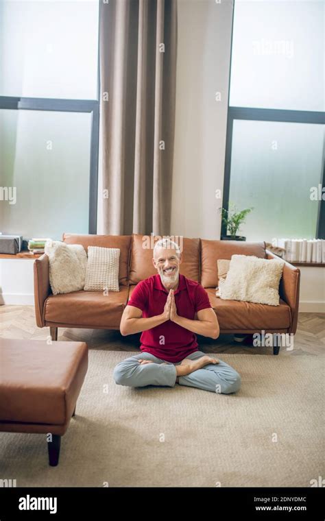 Grey-haired man sitting on the floor and doing yoga Stock Photo - Alamy