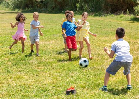 Group of Happy Schoolchildren Playing Football Together Stock Image ...