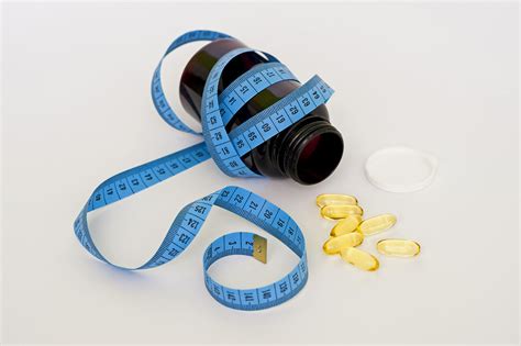 Weight Loss Pills Concept. Tape Measure and Pills