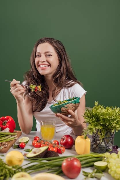 Premium Photo | Young woman eating healthy food sitting in the ...