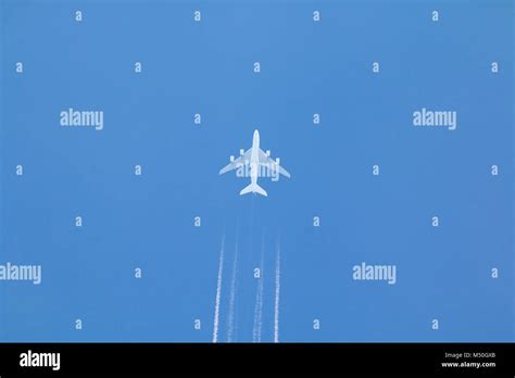 Jet Airplane with Vapor Trail Stock Photo - Alamy