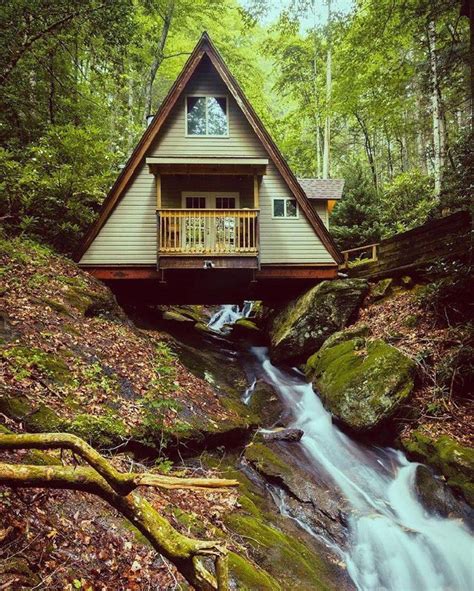 A cabin with a river underneath Check out desigedecors.com to get more inspiration # ...