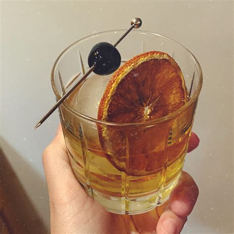 Old fashioned with dark cherry bitters and a dehydrated orange slice ...