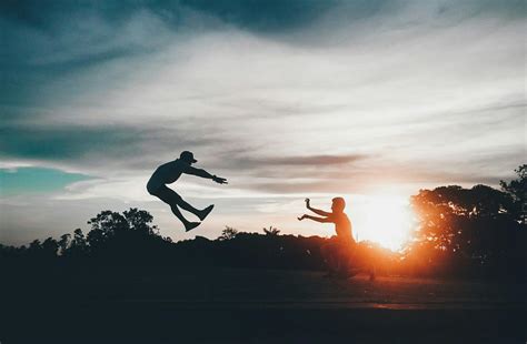 Silhouette Photography of Group of People Jumping during Golden Time · Free Stock Photo