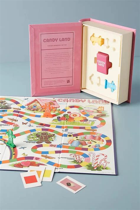 the candy land board game is open and ready to be played with its matching contents