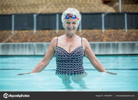 Senior woman swimming in pool Stock Photo by ©Wavebreakmedia 148220941