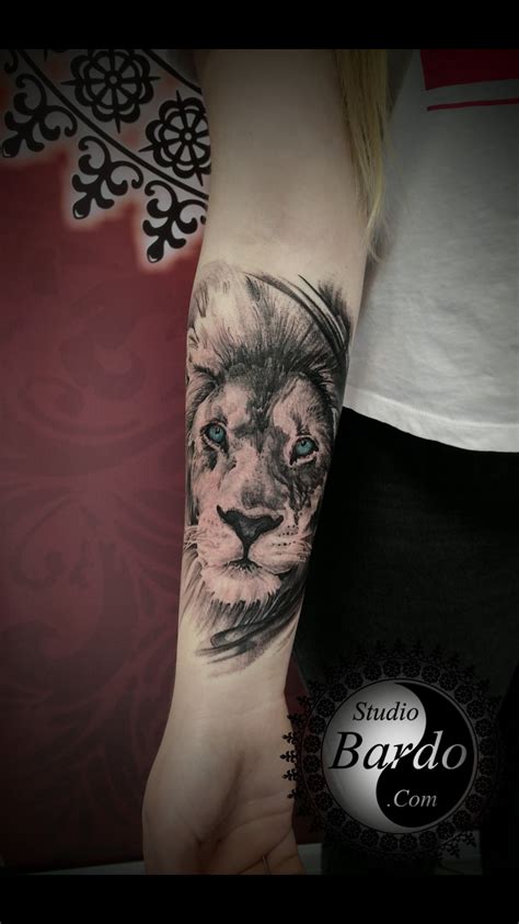 a woman's arm with a lion tattoo on the left side of her arm