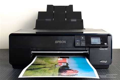 an epson printer sitting on top of a table next to a photo print machine