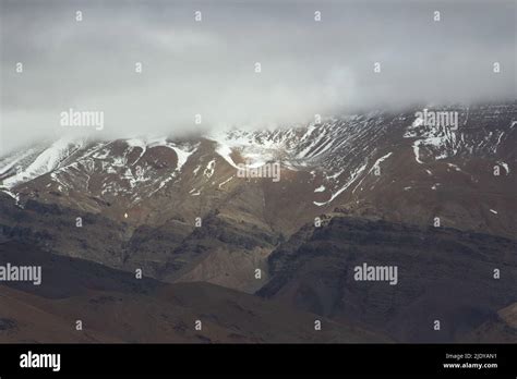 low cloud and mountain sides covered in snow in the High Atlas ...