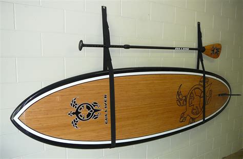 If you don't have the racking space in your garage to store a Stand Up Paddle Board, Strap it ...