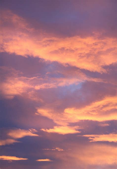 Download Spectacular 4K Display on iPhone 11 Pro Max Showcasing Pink and Yellow Clouds Wallpaper ...