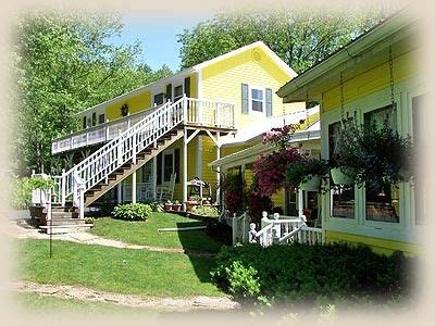 a yellow house with stairs leading up to it