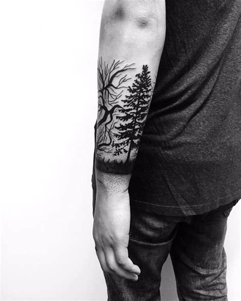 Black tree tattoo on the forearm - Tattoogrid.net